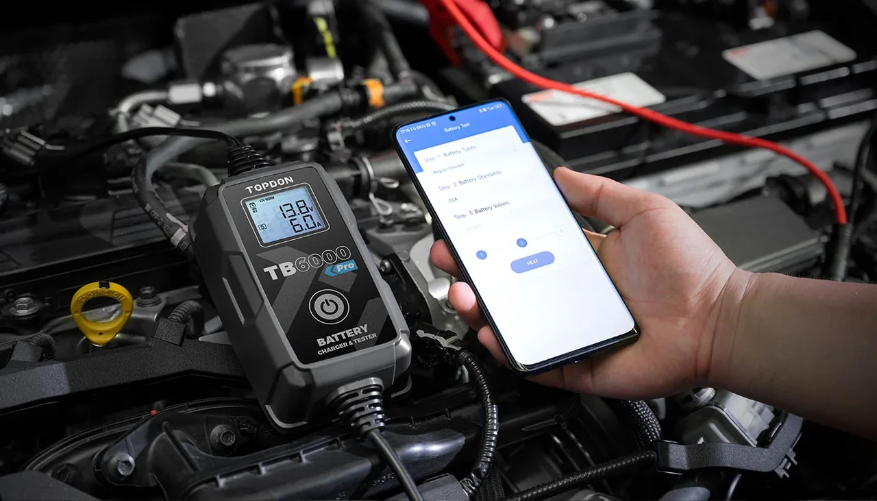 TOPDON TB6000 Pro running a battery test through the phone app in an engine bay