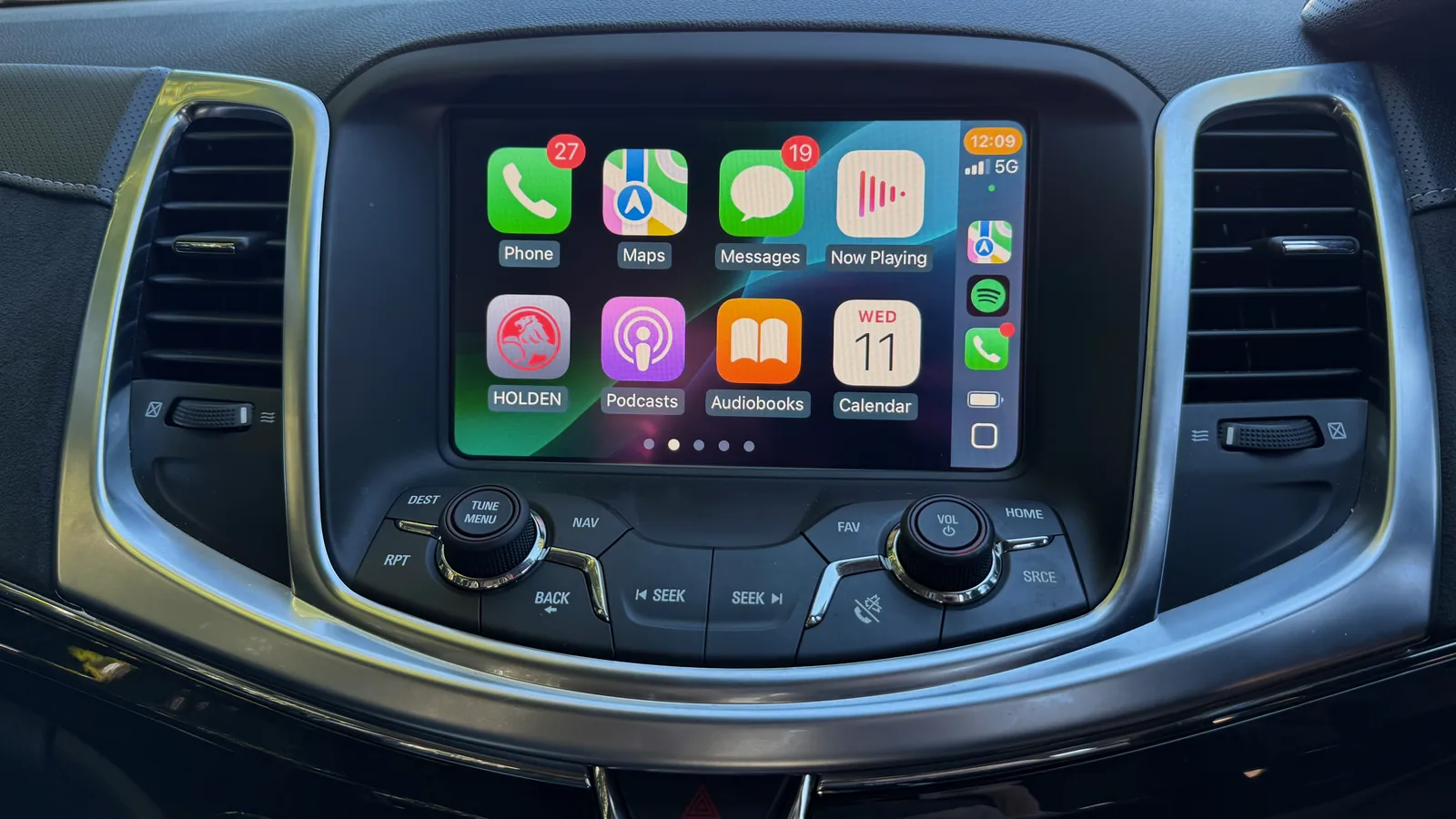 Apple CarPlay home screen on the factory MyLink display of a VF Commodore, original centre stack controls intact